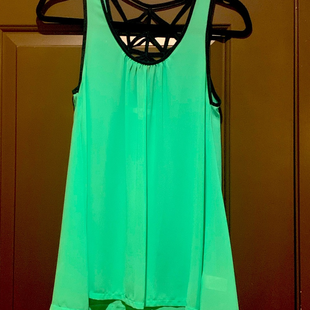 Beautiful green shirt. Women’s size S. Navy trim with cut out back! Very flowy.